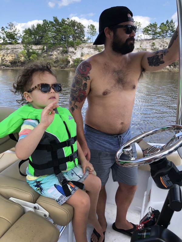 Teaching Our Nephew to Drive the Boat