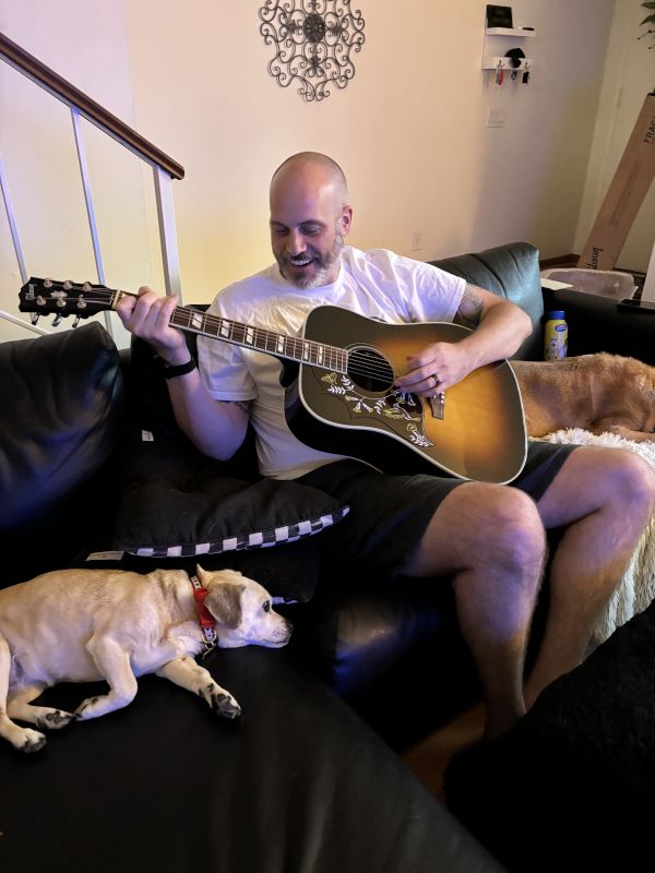Ron Playing Guitar for Our Dog Bisou