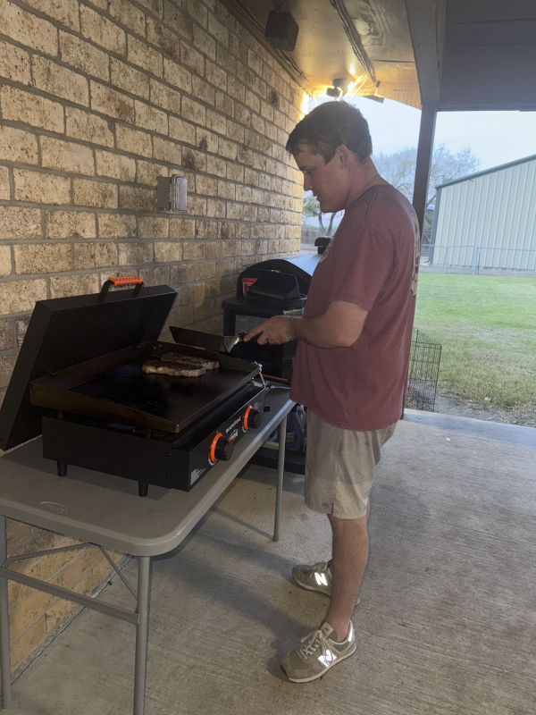 Tyler Cooking Dinner on Our Back Patio