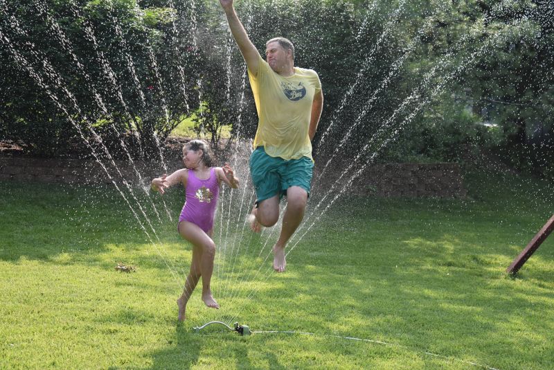 Molly and Nick Being Silly in the Sprinklers